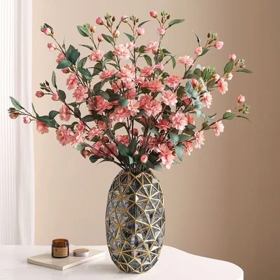 Un buen precio. Camelia flores artificiales, arreglos florales de camalelia de varias cabezas, ramas largas, flores artificiales, decoración del hogar en línea