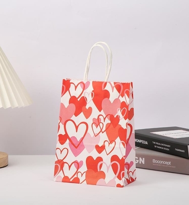 Un buen precio. El regalo de papel rojo de 80gsm Kraft empaqueta el papel impreso corazón Goodie del amor empaqueta con las manijas en línea